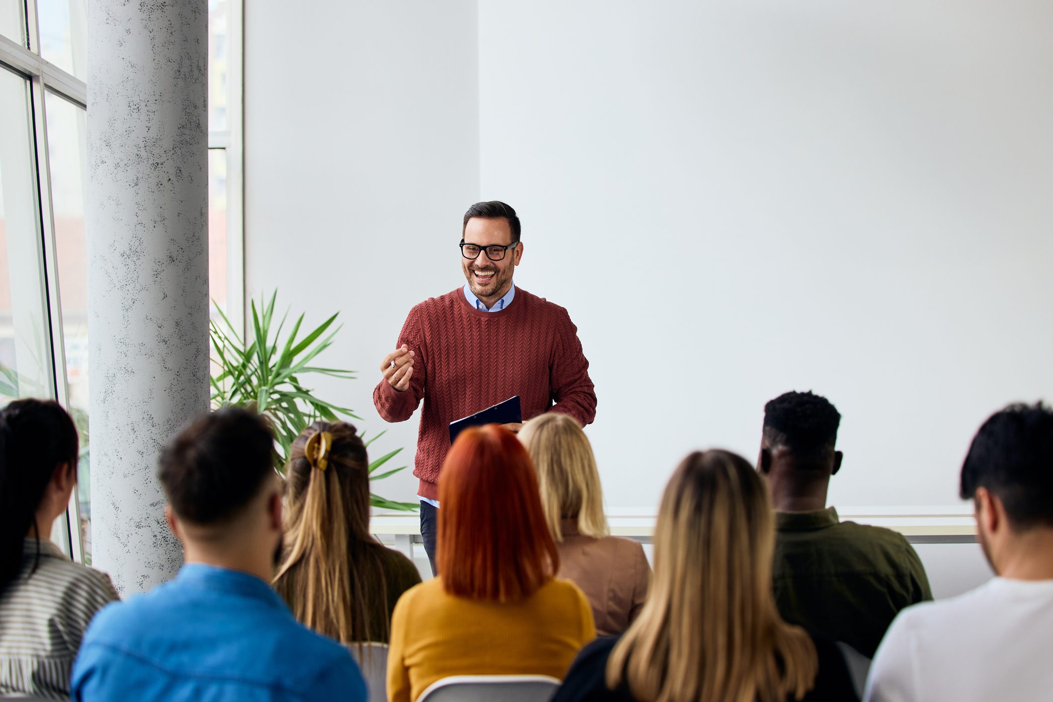 Man presenting to seated audience in seminar