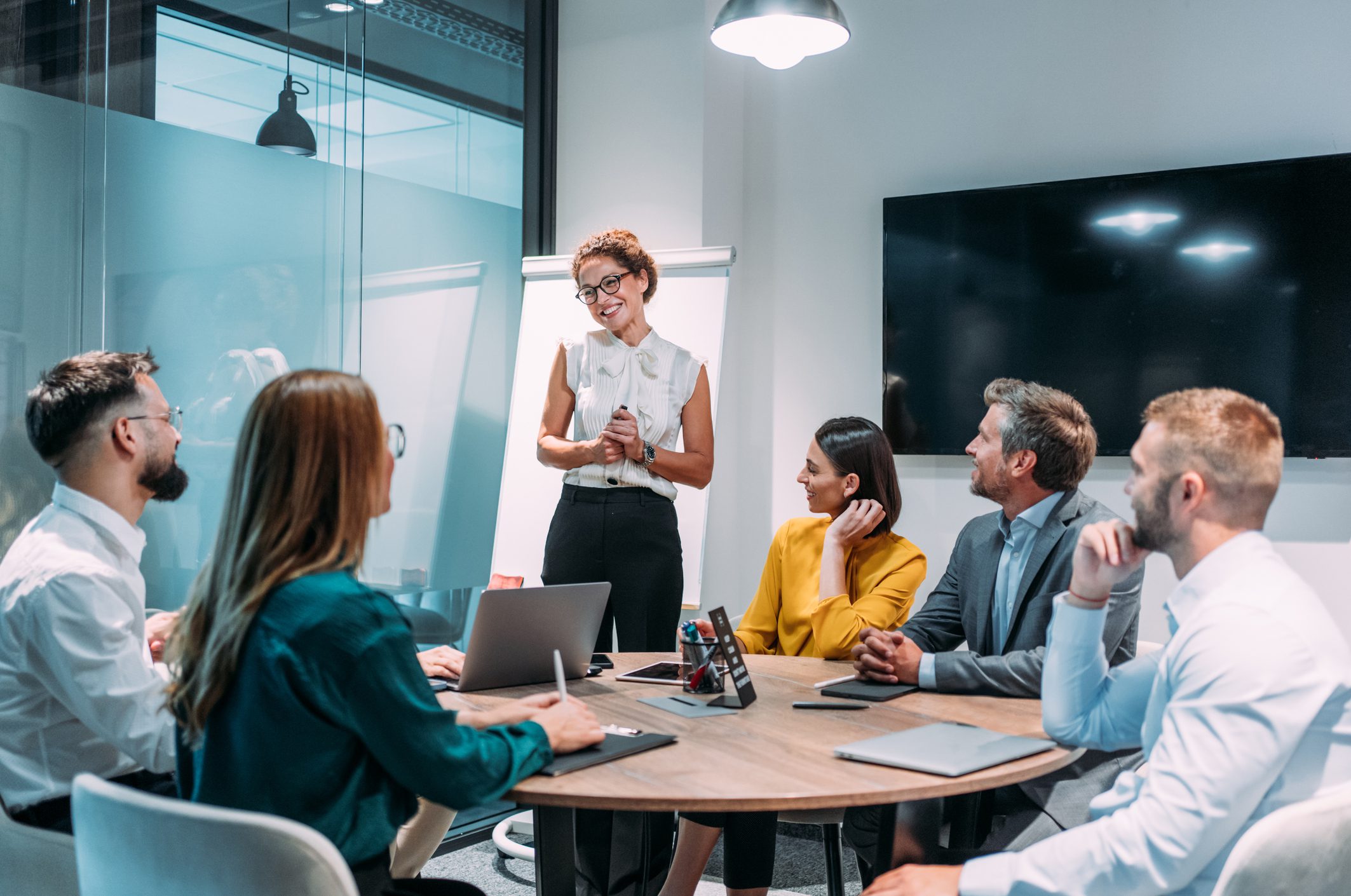 Business team meeting with woman presenter