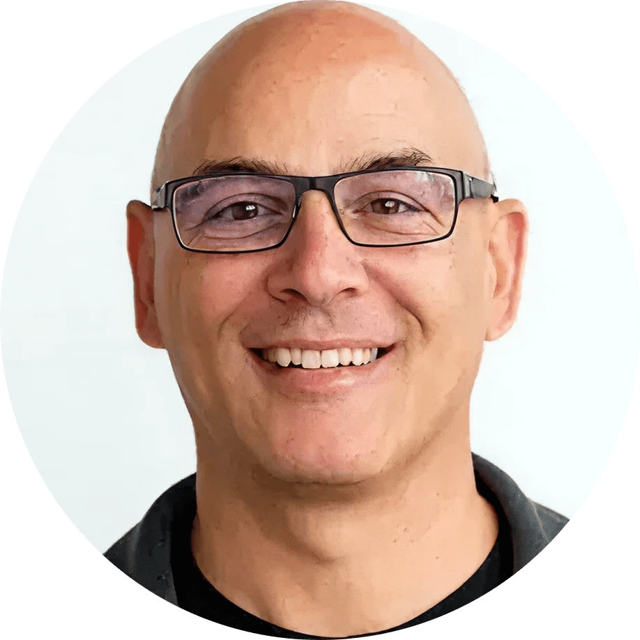 Smiling bald man wearing glasses headshot