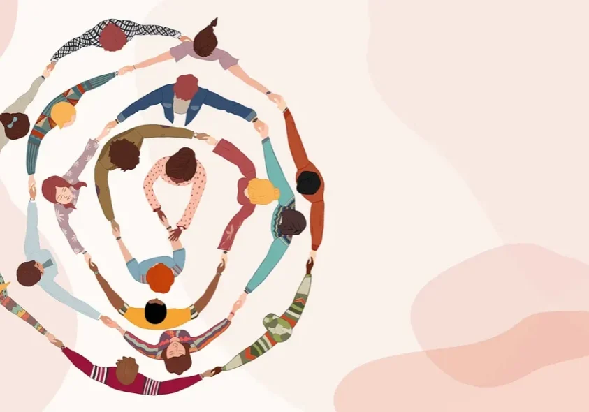 People holding hands in concentric circles
